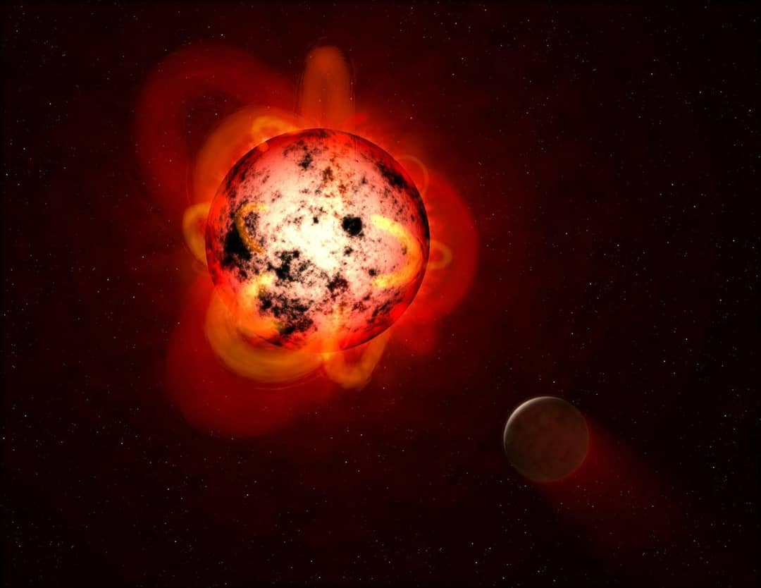 Illustrazione di una nana rossa in attività con eruzioni stellari